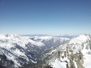From the summit: the rest of the summit mound in the foreground. Mountains in the background. A great day and view in both.