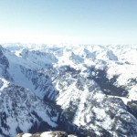 From the summit: more washed out mountains and the tip of Stuart - king of the range - just in view on the left.